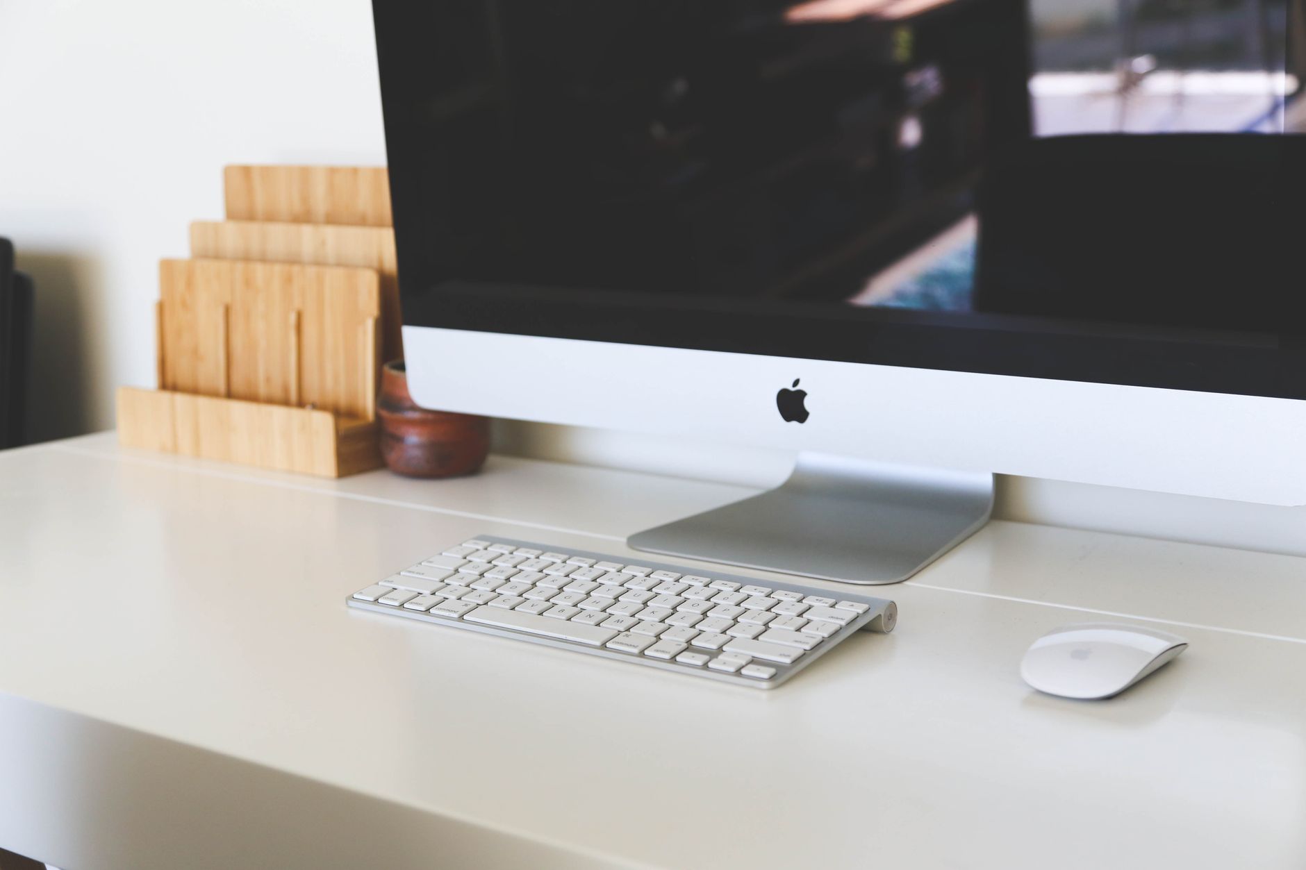 A clean and modern home office workspace featuring an iMac